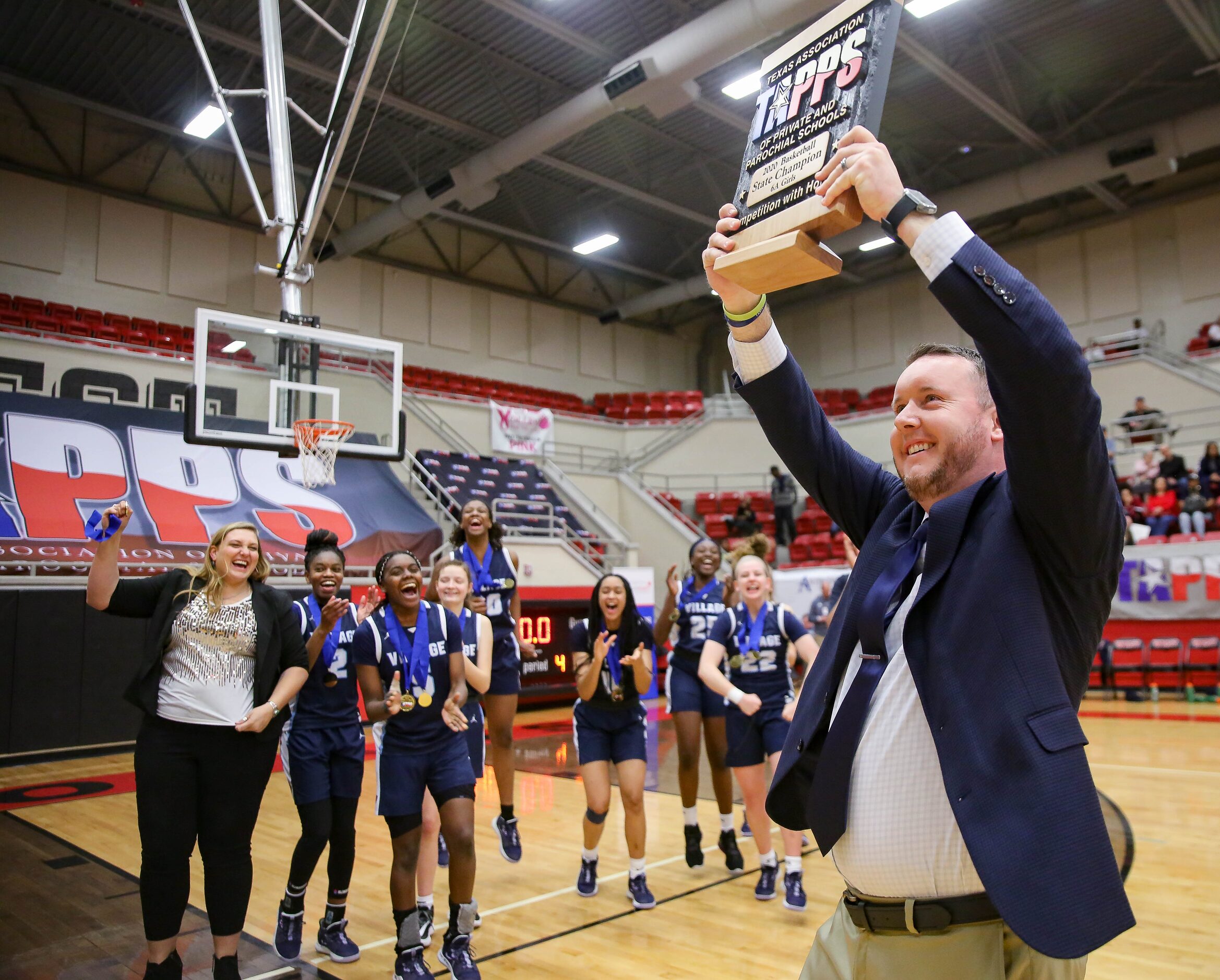 The Village School coach Doug Brotherton celebrates after beating Plano Prestonwood...