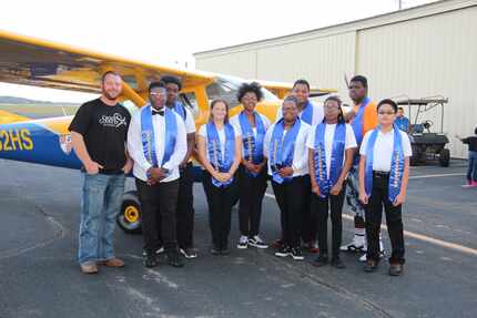 Lancaster students pose with the plane they built to fly humanitarian missions to...
