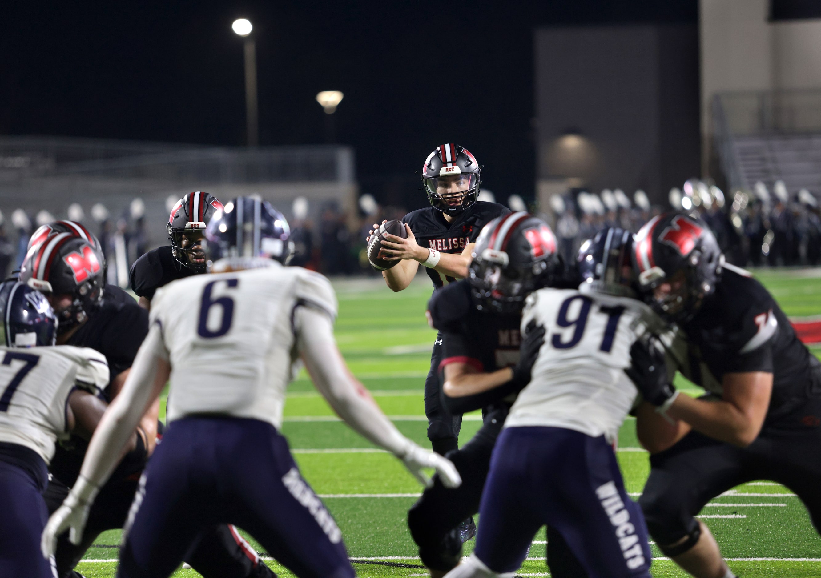 Melissa player #10 Noah Schuback receives the snap during the Prosper Walnut Grove High...