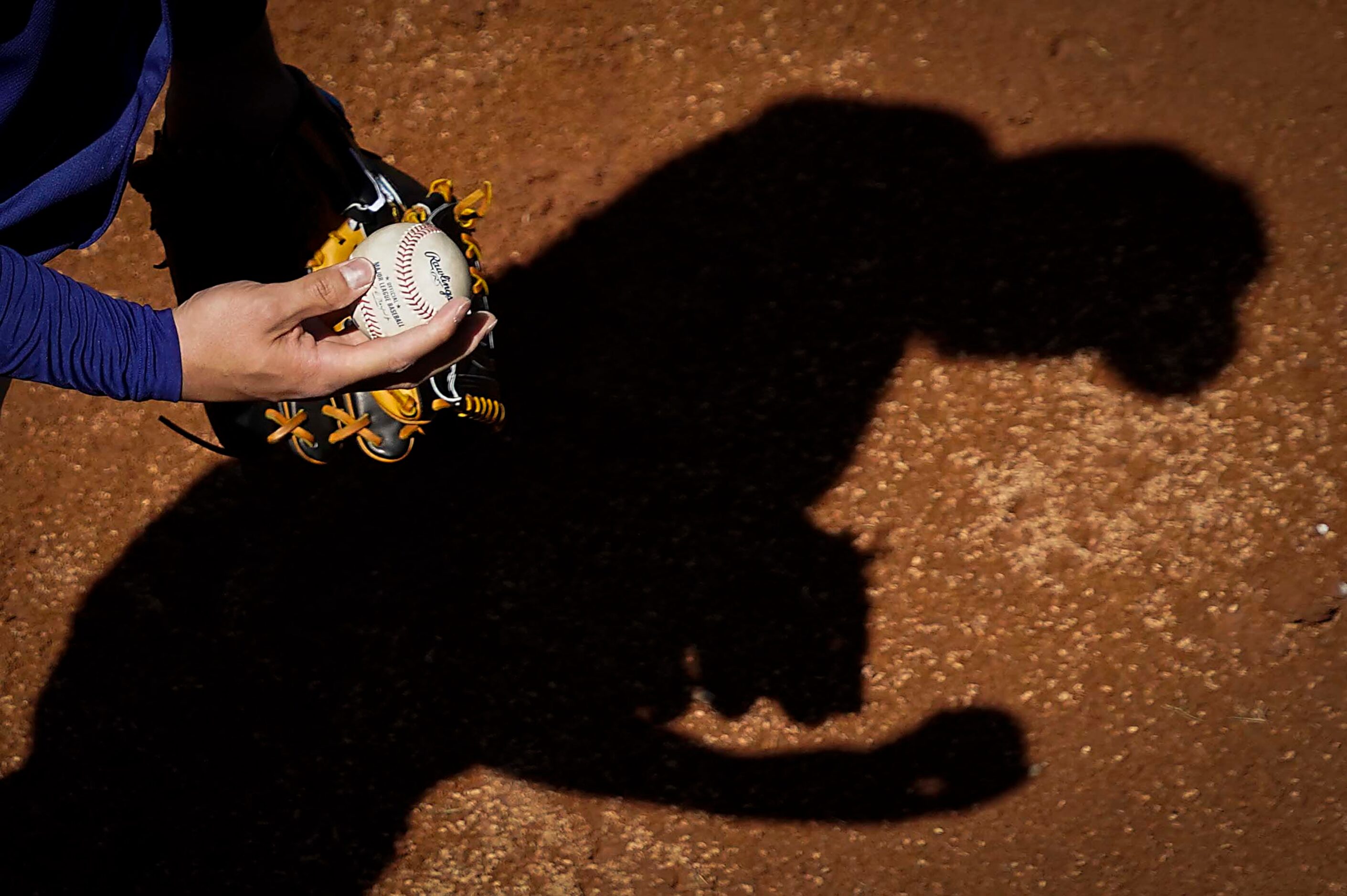 Texas Rangers pitcher Kohei Arihara warms up in the bullpen before a spring training game...