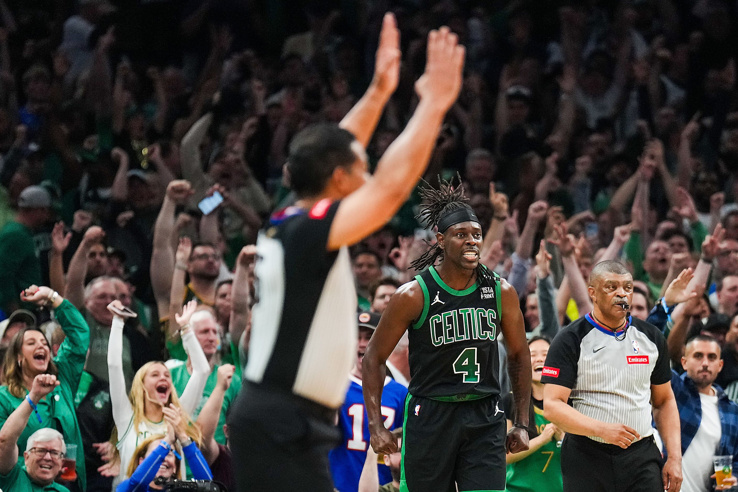 Boston Celtics guard Jrue Holiday (4) celebrates after hitting a 3-pointer during the first...