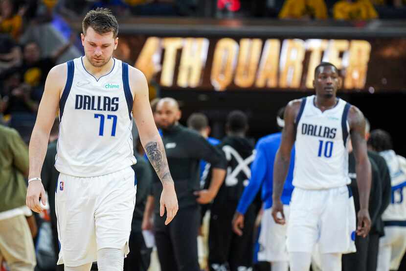 Dallas Mavericks guard Luka Doncic (77) and forward Dorian Finney-Smith (10) take the court...