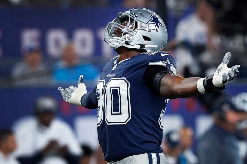 Dallas Cowboys defensive end DeMarcus Lawrence (90) celebrates his first quarter sack of New...