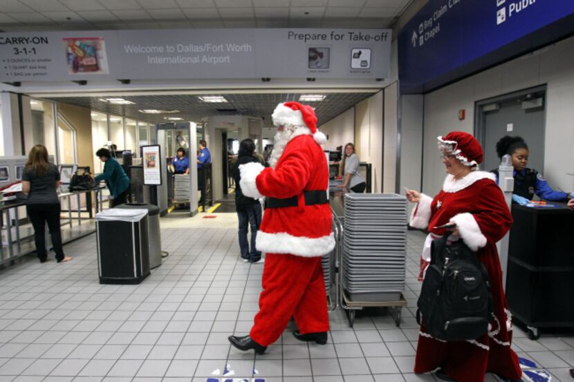 Even Santa and Mrs. Claus have to make their way through airport security. D/FW...