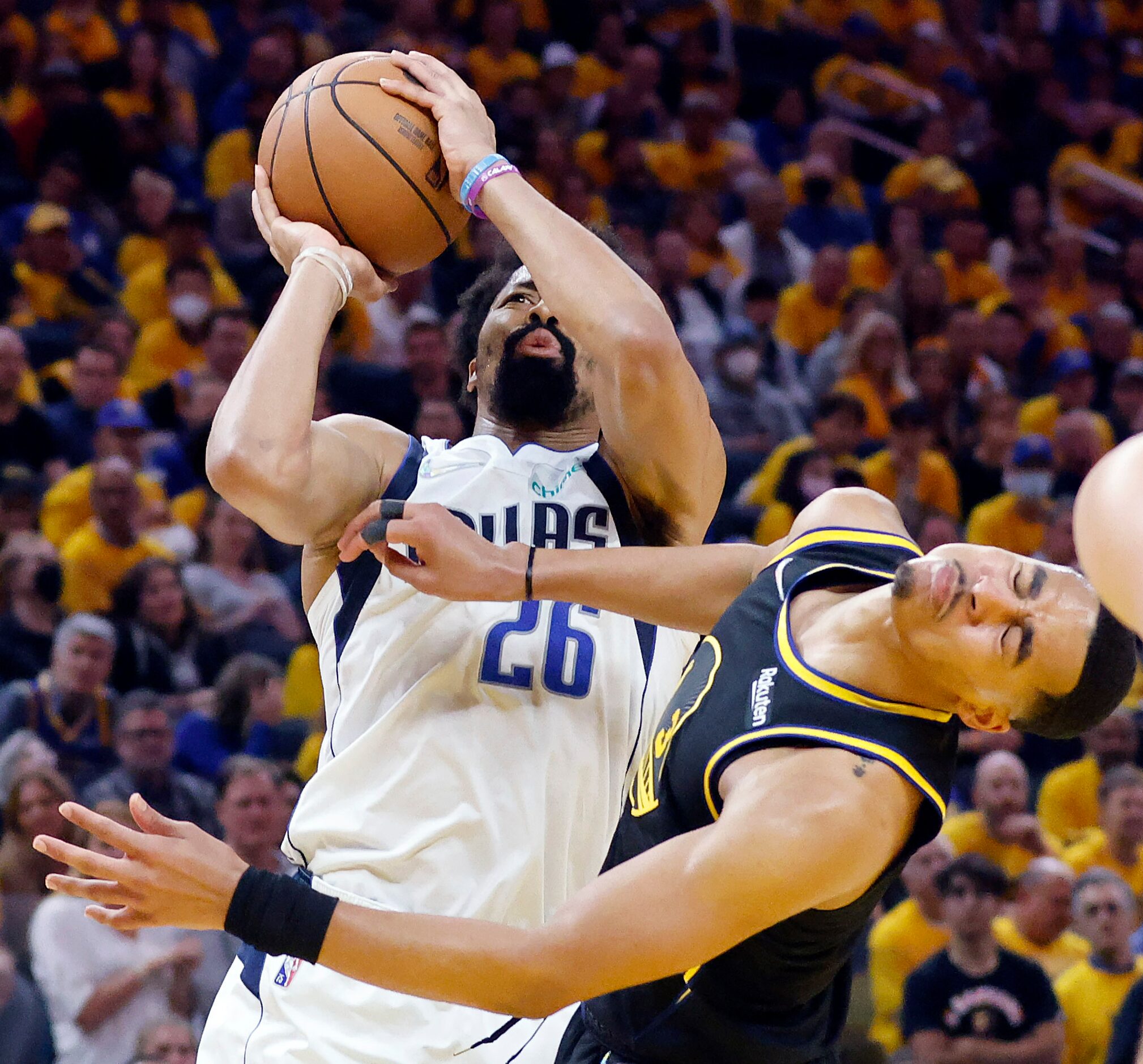 Golden State Warriors guard Jordan Poole (3) recoils after being hit by Dallas Mavericks...