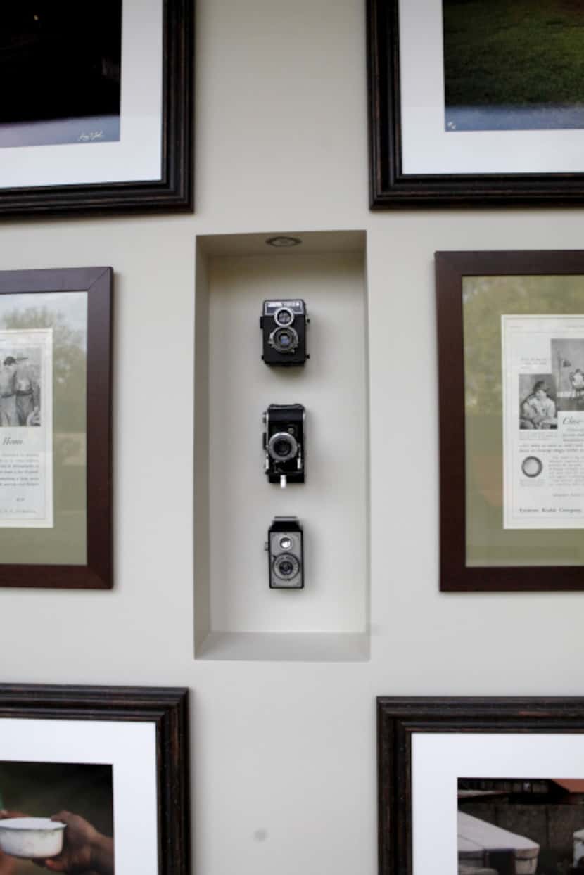 A hallway with photographer Jeremy Lock's photographs and cameras at the home of D'Andra...