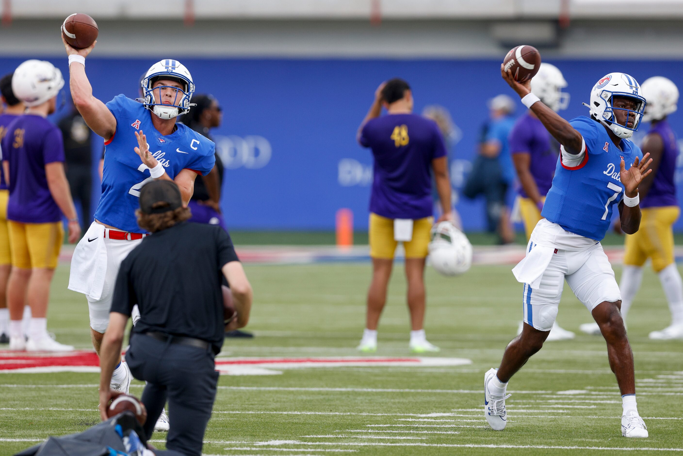 SMU quarterbacks Preston Stone (2) and Kevin Jennings (7) warm up before the first half of...