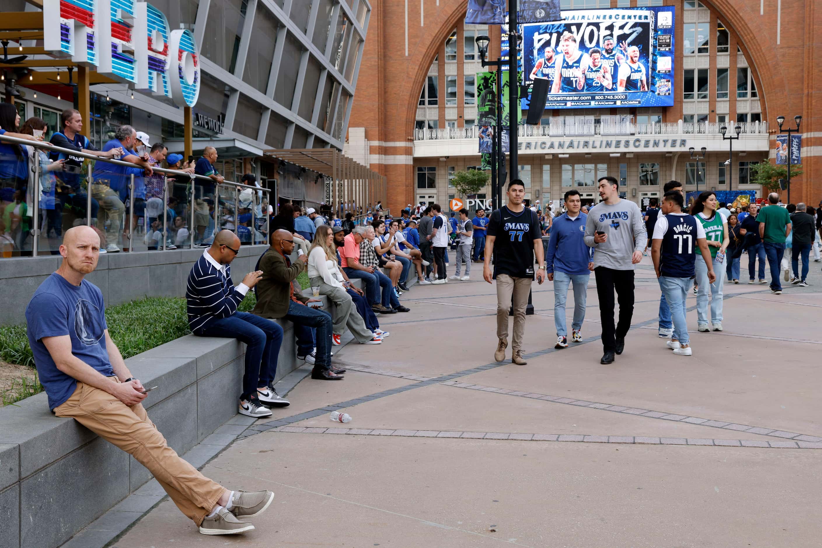 Fans sit outside the American Airlines Center before Game 3 of an NBA basketball first-round...