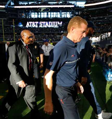Dallas head coach Jason Garrett walks off the field after losing 20-19 to the Giants during...