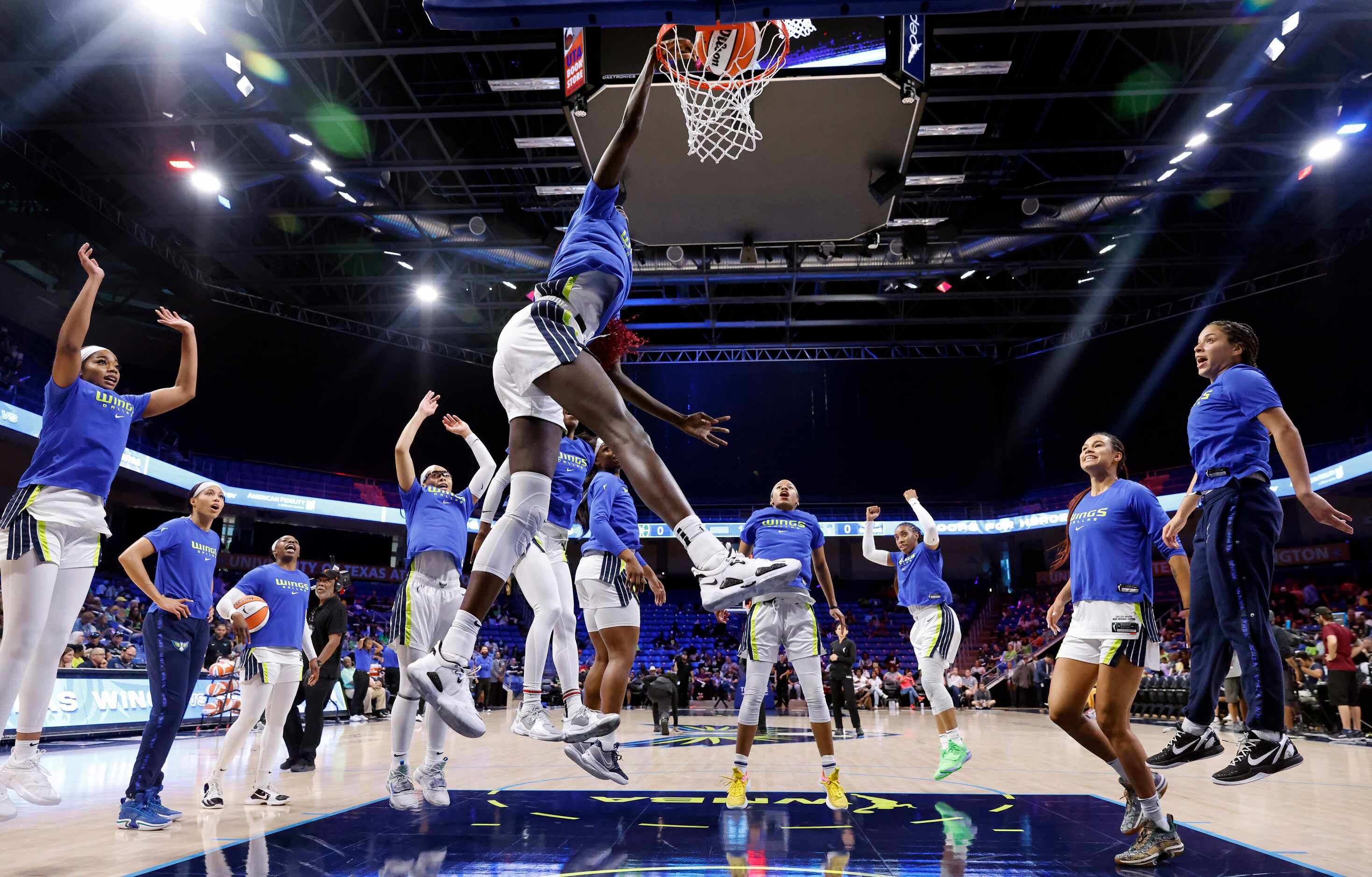 Dallas Wings center Awak Kuier (28) performs her traditional pregame dunk as her teammates...