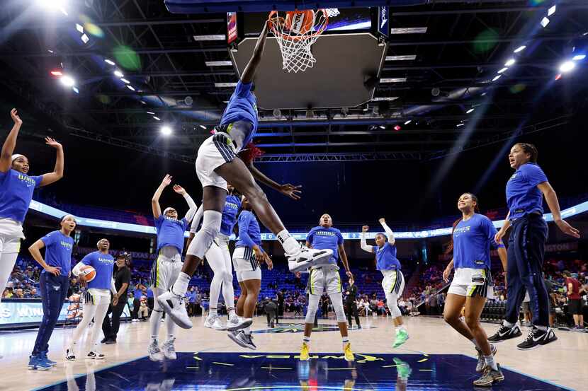 Dallas Wings center Awak Kuier (28) performs her traditional pregame dunk as her teammates...