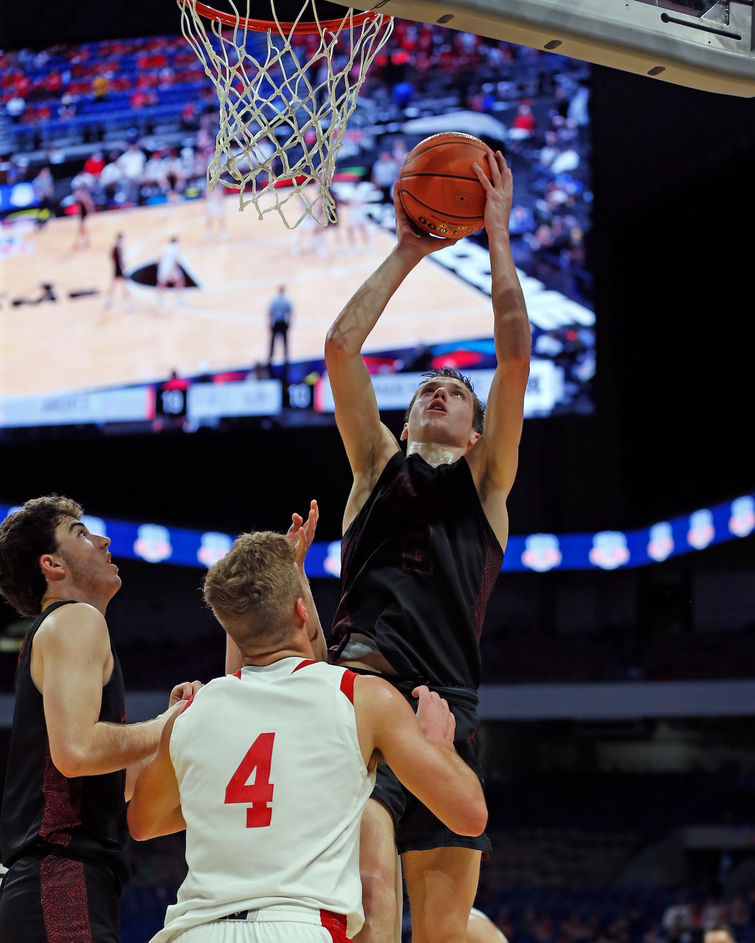 Argyle Nate Atwood #4 shoots over Huffman Hargrave Luke Thomas #4 in first quarter. UIL boys...