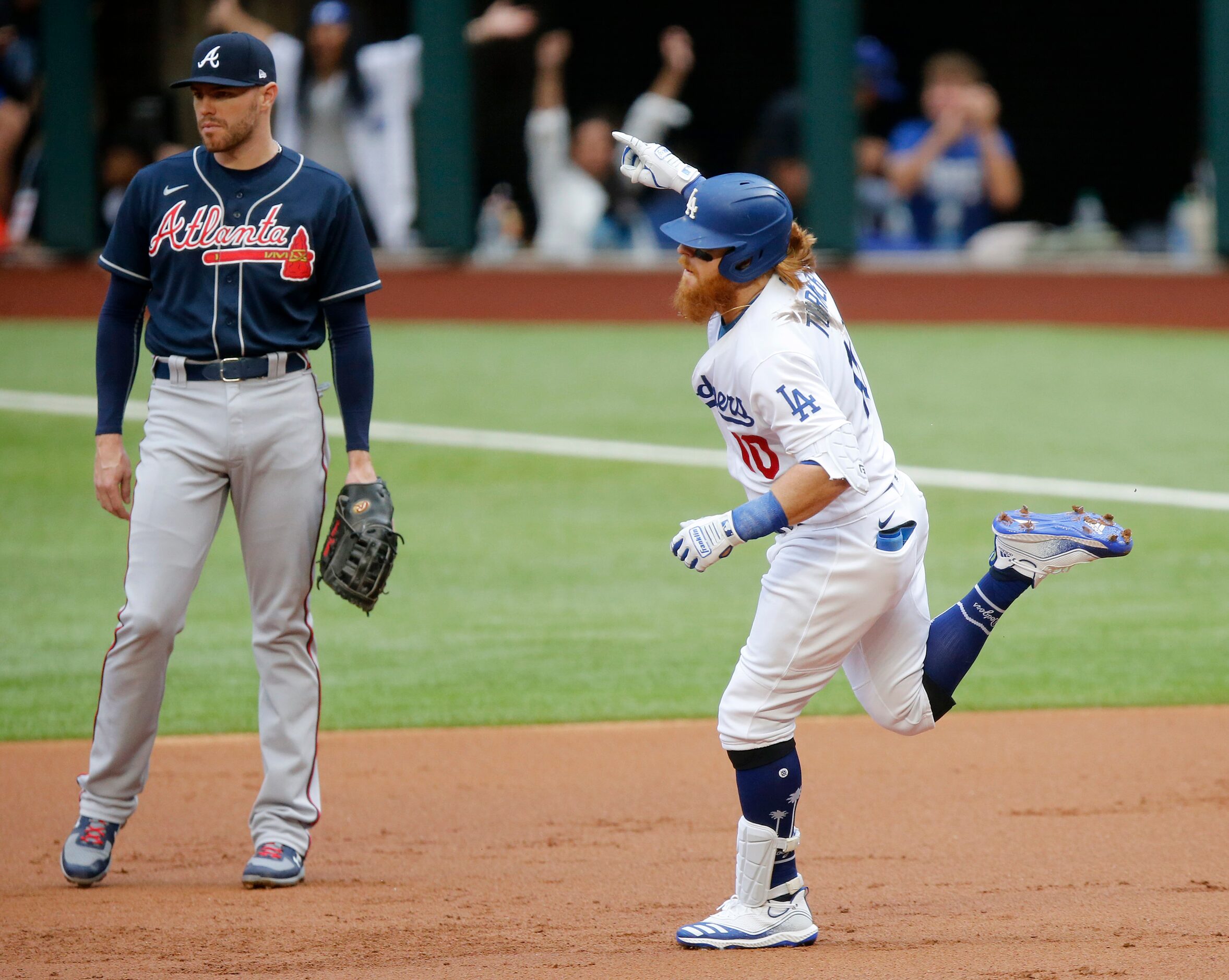 Los Angeles Dodgers Justin Turner (10) celebrates his first inning solo home run as he...