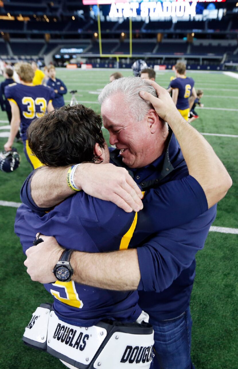 Highland Park junior quarterback John Stephen Jones, left, is congratulated by his father,...