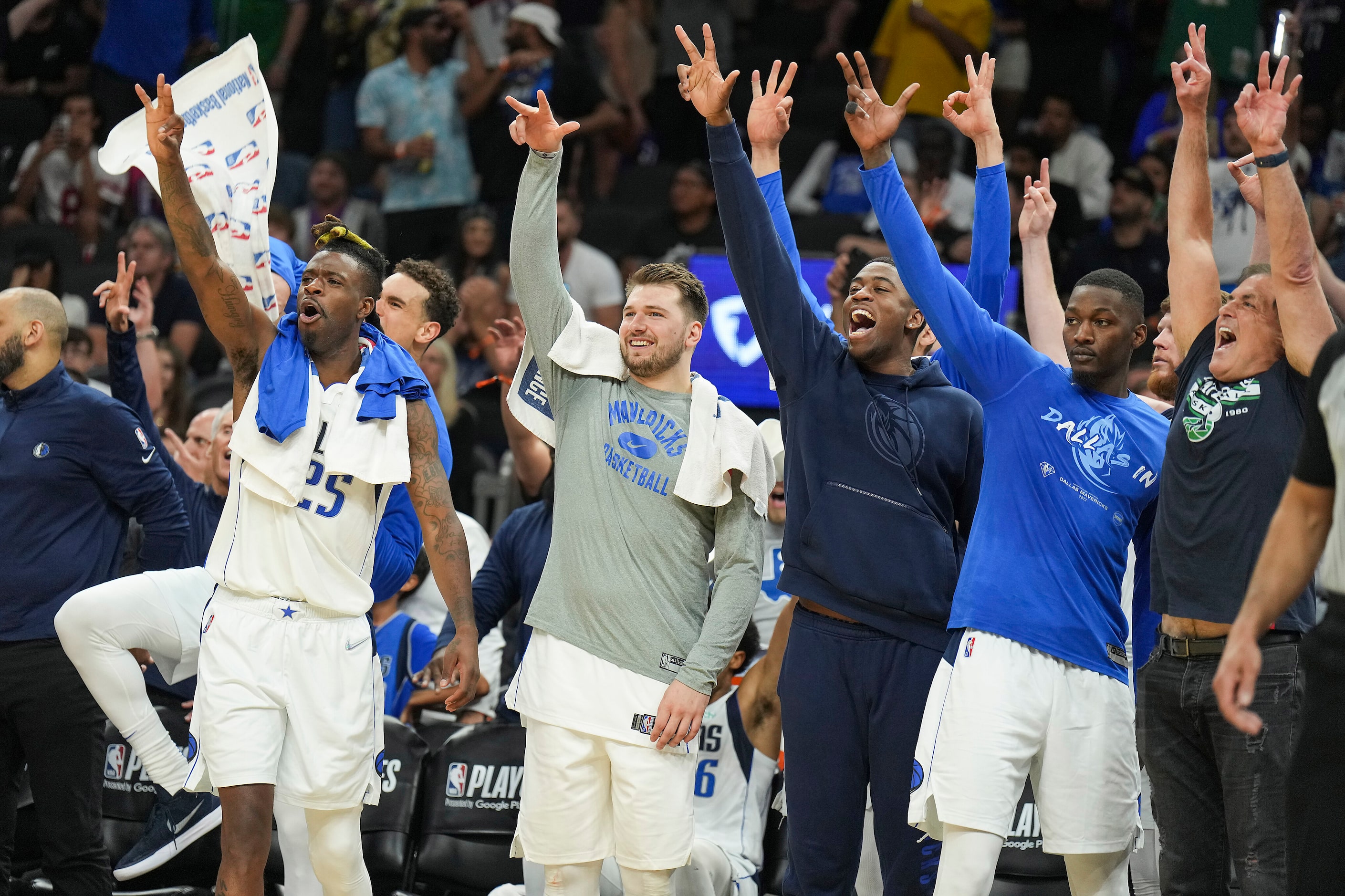 Dallas Mavericks players (from left) Reggie Bullock (25), Dwight Powell (behind Bullock),...