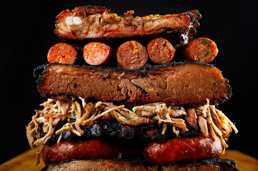 Brisket, ribs, sausage, and pulled pork are piled high, Thursday, July 12, 2018. Barbecue...