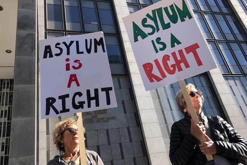 Protestors hold signs that read " Asylum is a Right" outside of the San Francisco Federal...