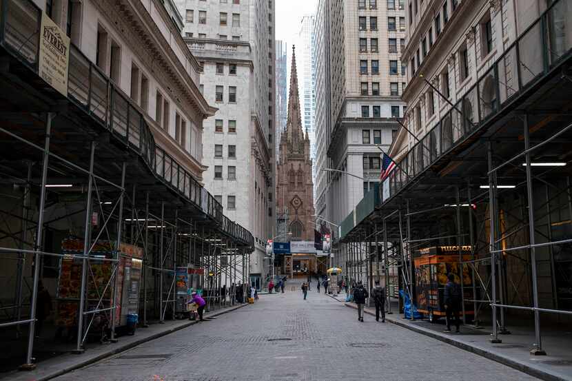 This photo from March 16 shows sparse pedestrian traffic along Wall Street in Lower...