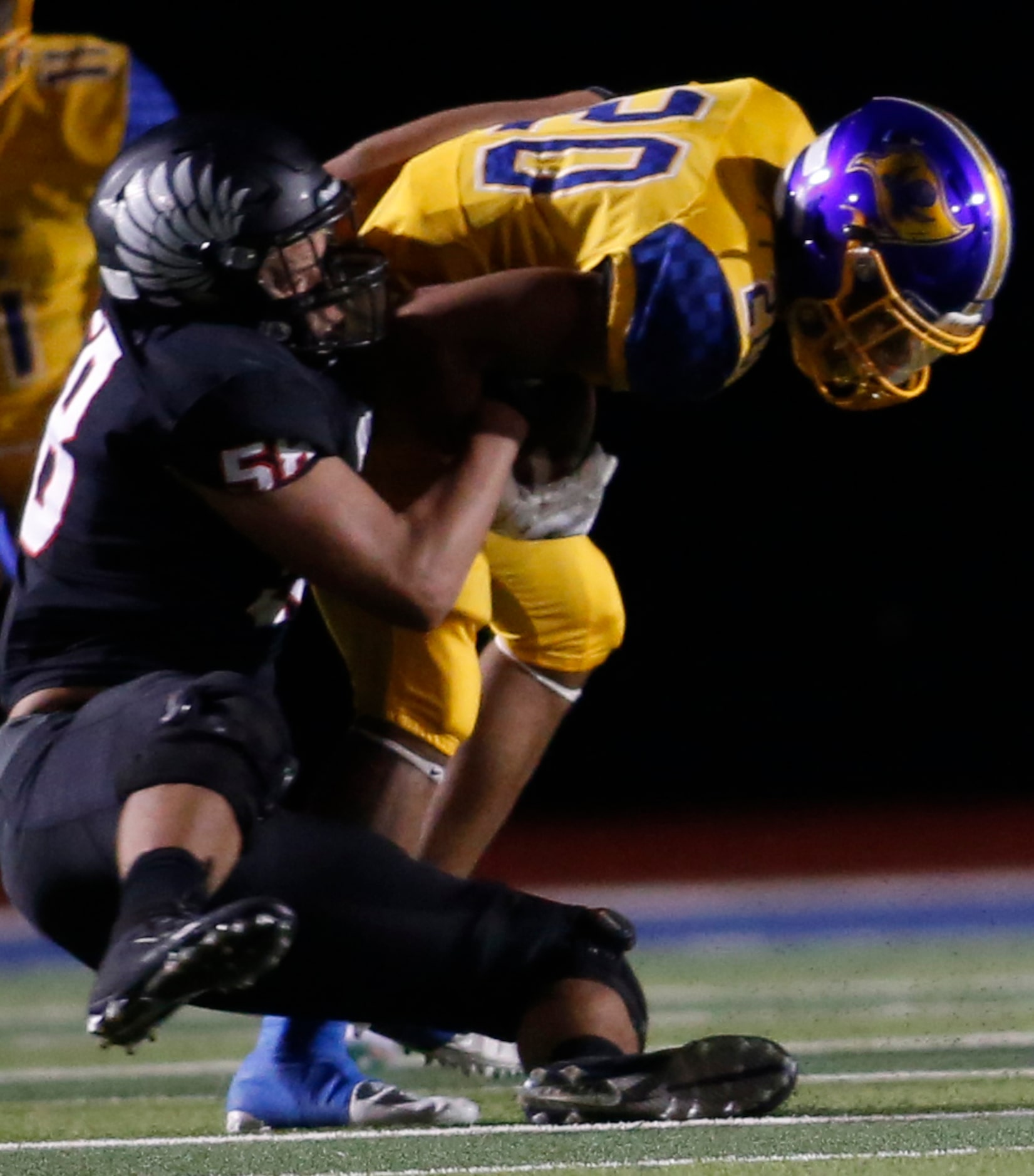 Argyle defensive lineman Michael Madrie (58) wraps up Waco LaVega running back Jordan Rogers...