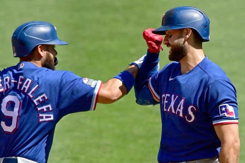ANAHEIM, CA - SEPTEMBER 21: Isiah Kiner-Falefa #9 of the Texas Rangers is congratulated by...