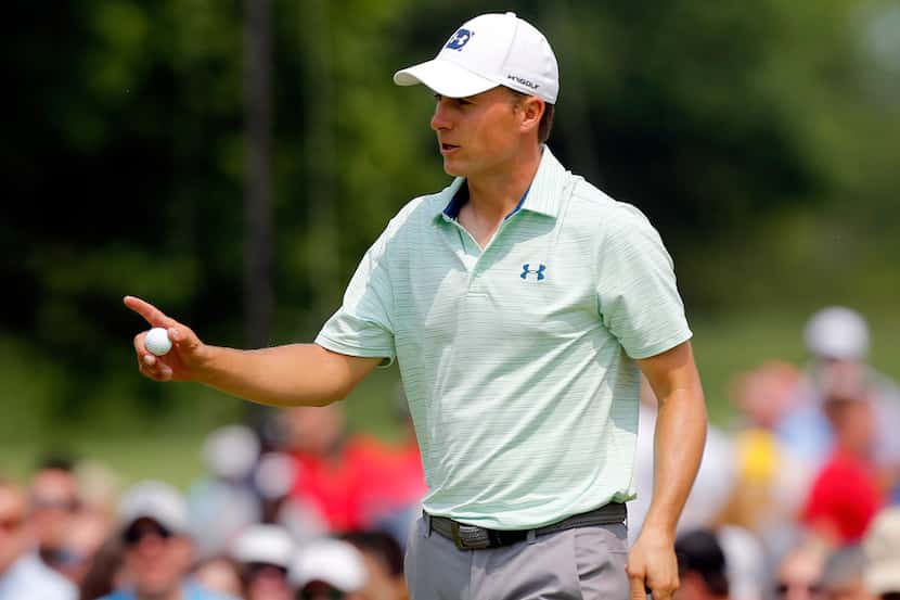 Jordan Spieth reacts to the crowd after finishing the ninth hole during the second round of...