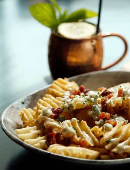 Hickory waffle fries with Maytag blue cheese, bacon and scallions and a Moscow mule