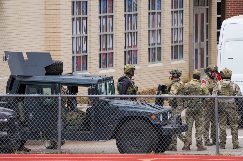 Law enforcement teams stage near Congregation Beth Israel.