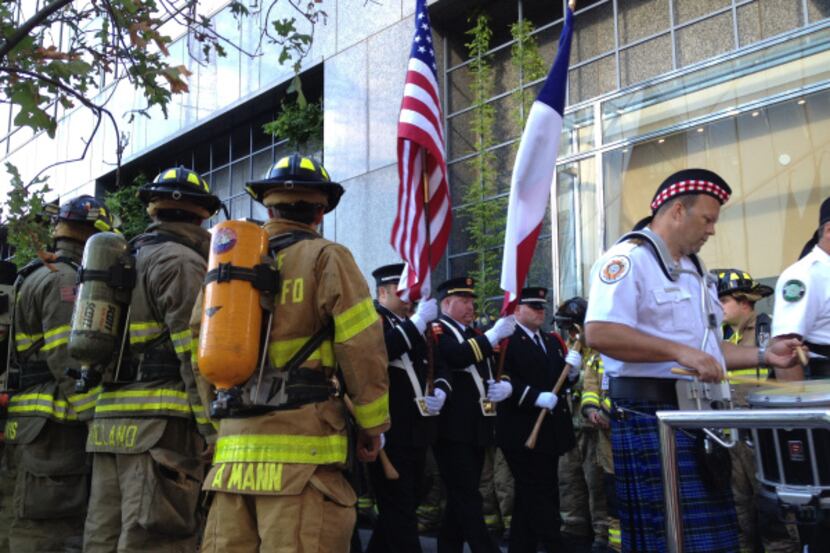 Members of the Dallas Firefighters Pipes and Drums march from the courtyard at Renaissance...