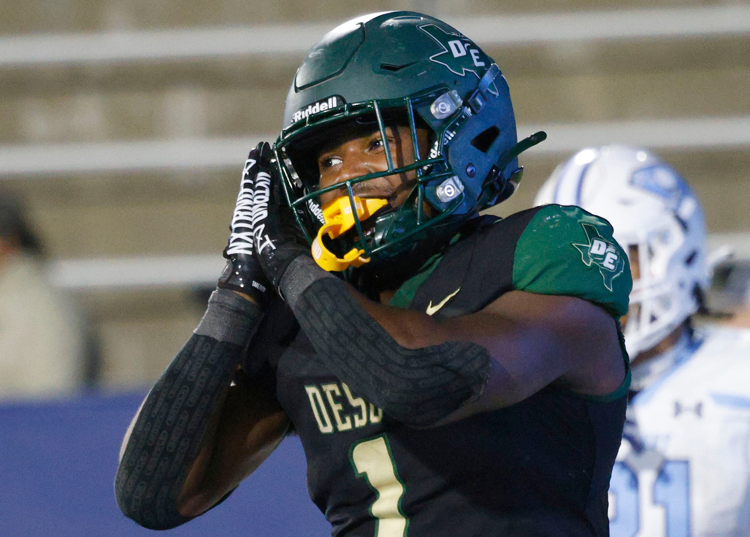 DeSoto's Deondrae Riden Jr. (1) reacts after scoring a touchdown against Wylie East in the...