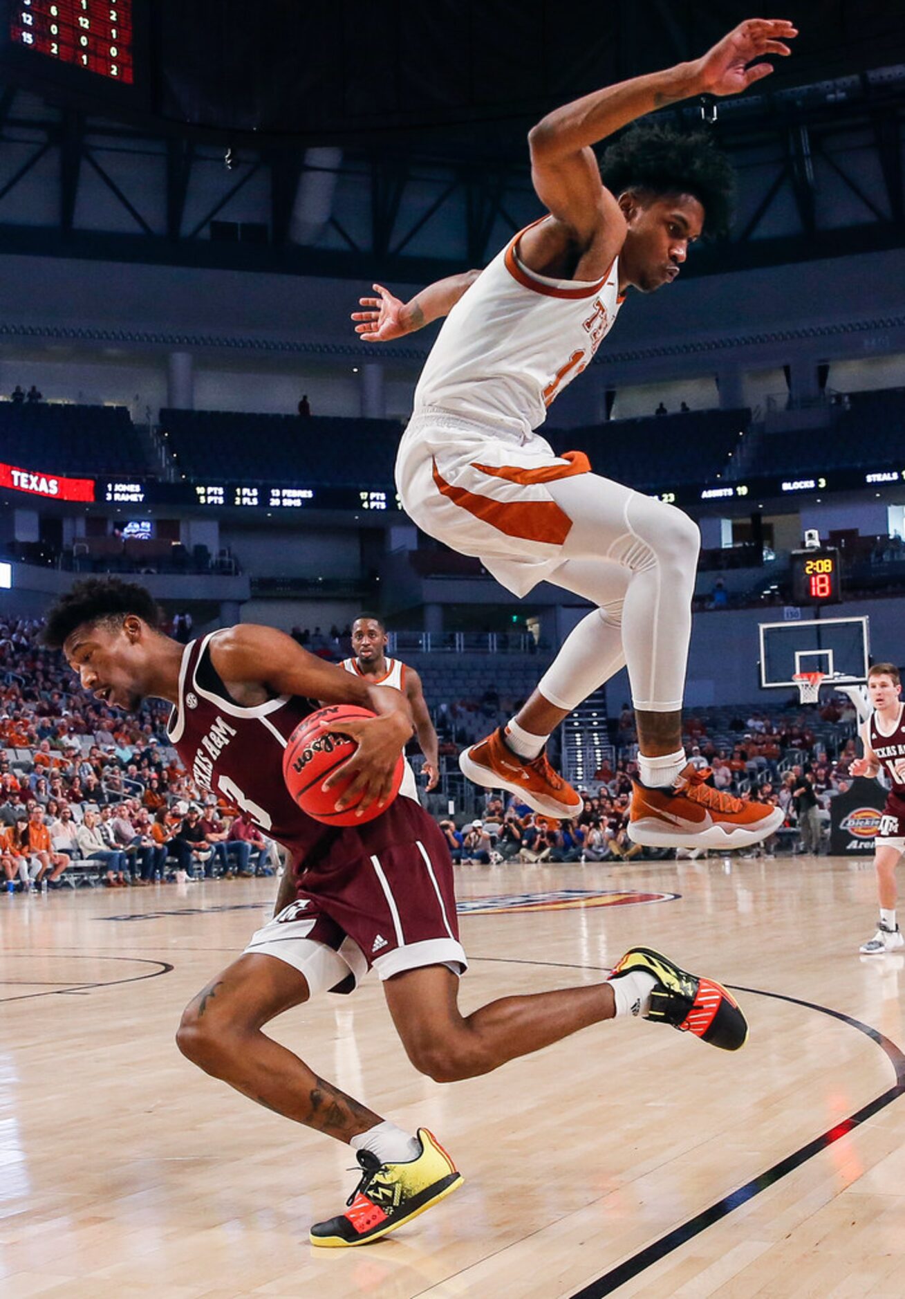 Texas A&M Aggies guard Quenton Jackson (3) drives underneath Texas Longhorns guard Jase...