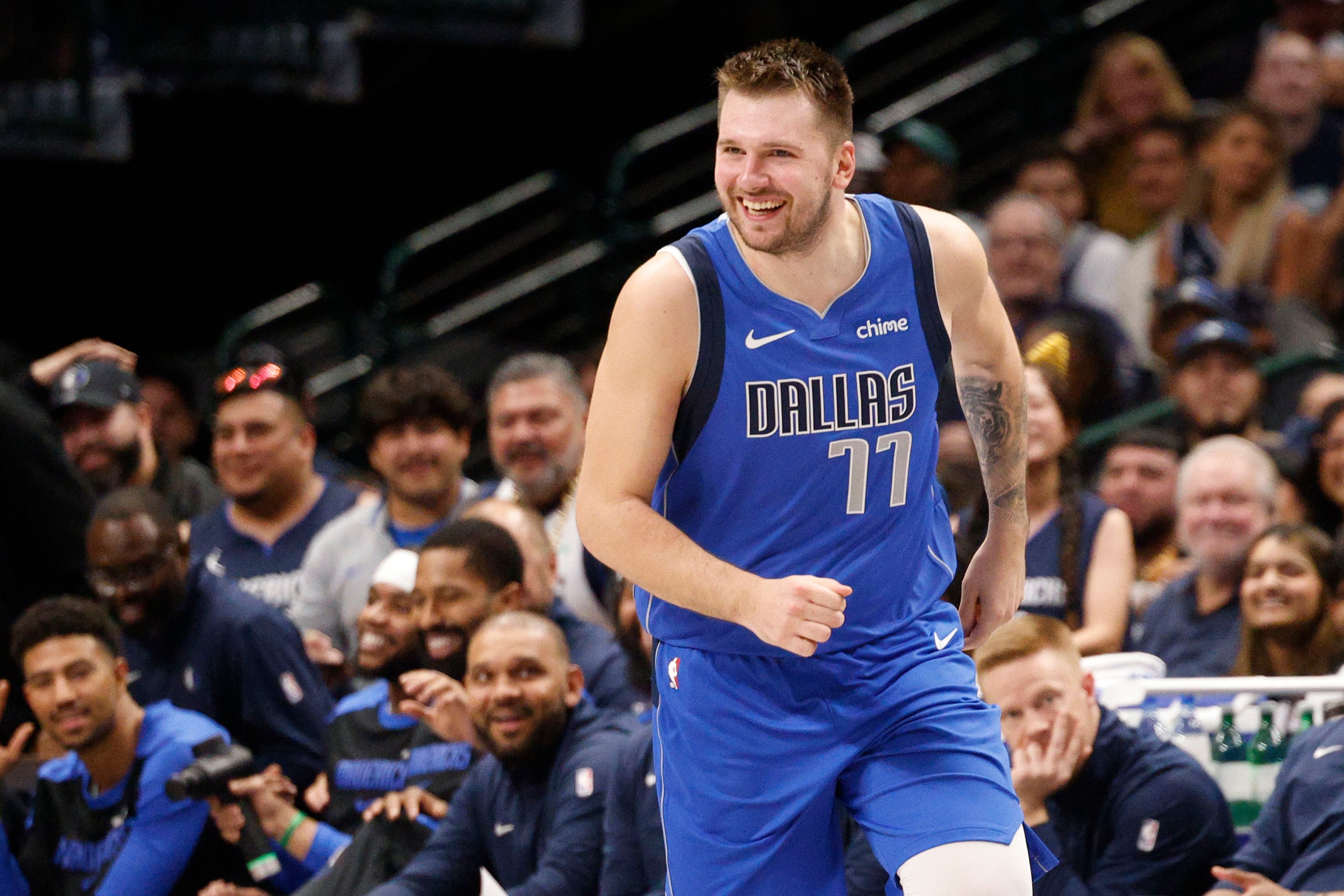 Dallas Mavericks guard Kyrie Irving (11) smiles after scoring against the Chicago Bulls...