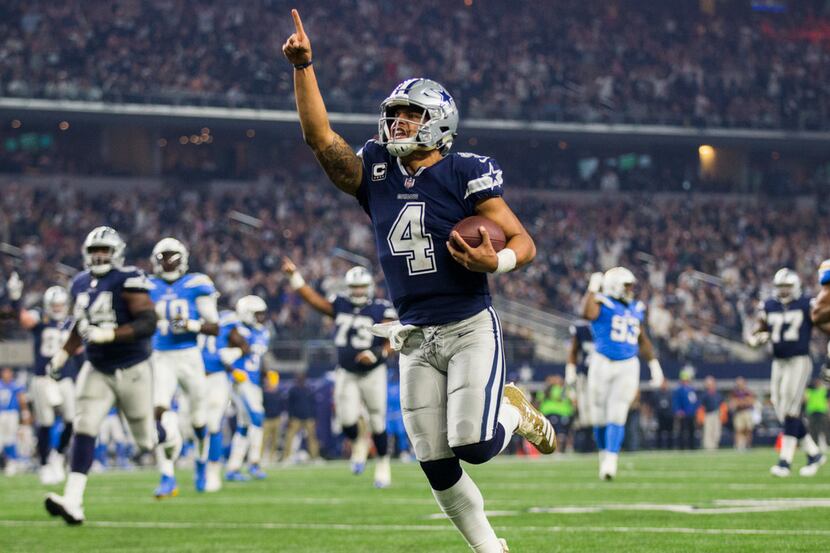 Dallas Cowboys quarterback Dak Prescott (4) runs to the end zone during the third quarter of...