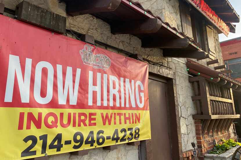 A "NOW HIRING' sign advertises the help needed at El Ranchito Mexican restaurant on...