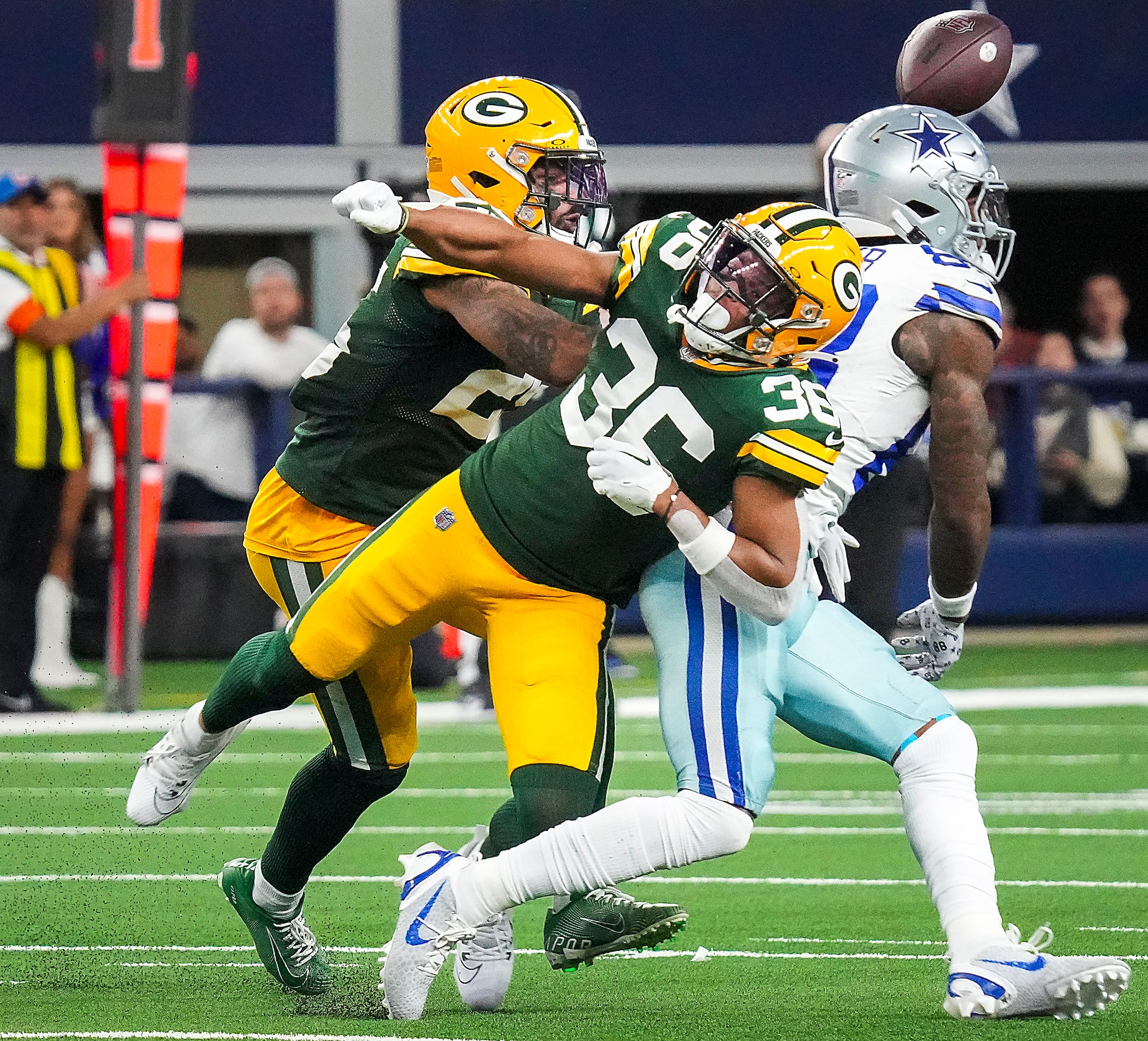 Green Bay Packers safety Anthony Johnson Jr. (36) breaks up a pass intended for Dallas...