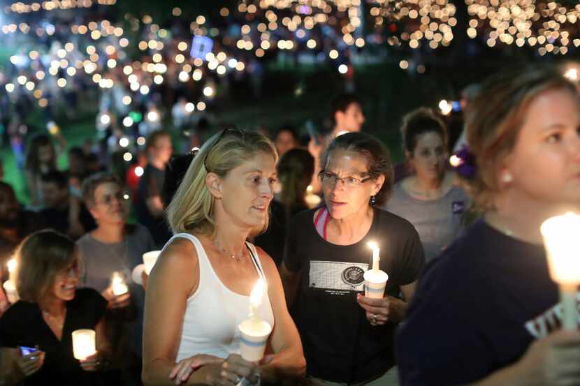 People participate in a candlelight vigil at the University of Virginia Wednesday night,...