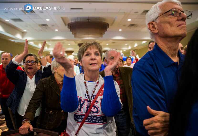 Debbie Bertrand applauds at the Hilton Arlington as supporters of a new stadium for the...