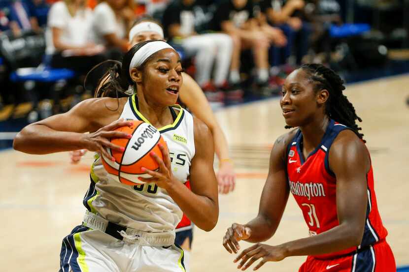 Dallas Wings forward/center Charli Collier (35) secures a rebound in front of Washington...