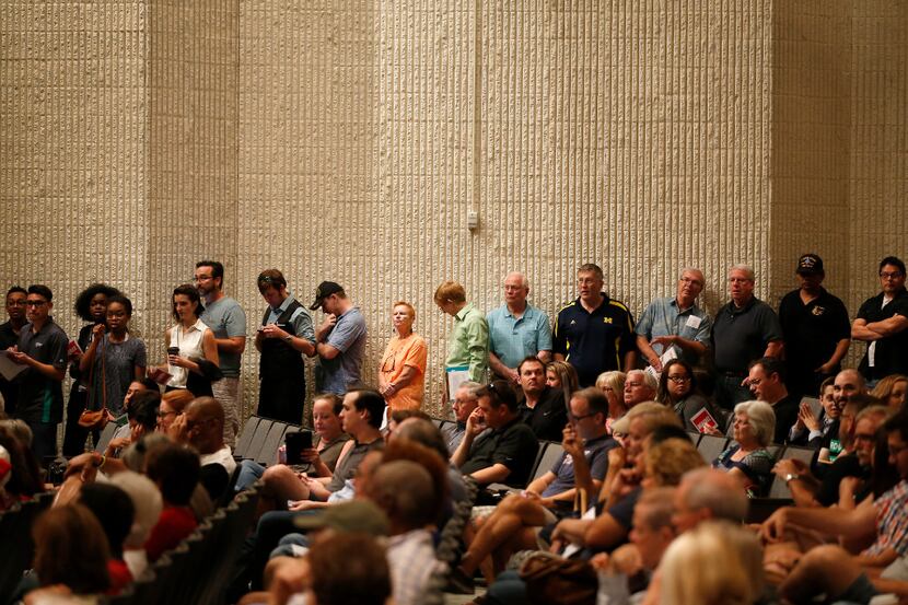 People stay in line to ask questions for Rep. Michael Burgess during an open forum town hall...