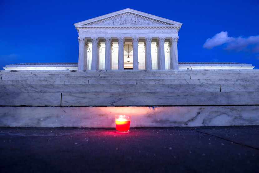  A candle is seen at the steps of the US Supreme Court February 13, 2016 in Washington, DC,...