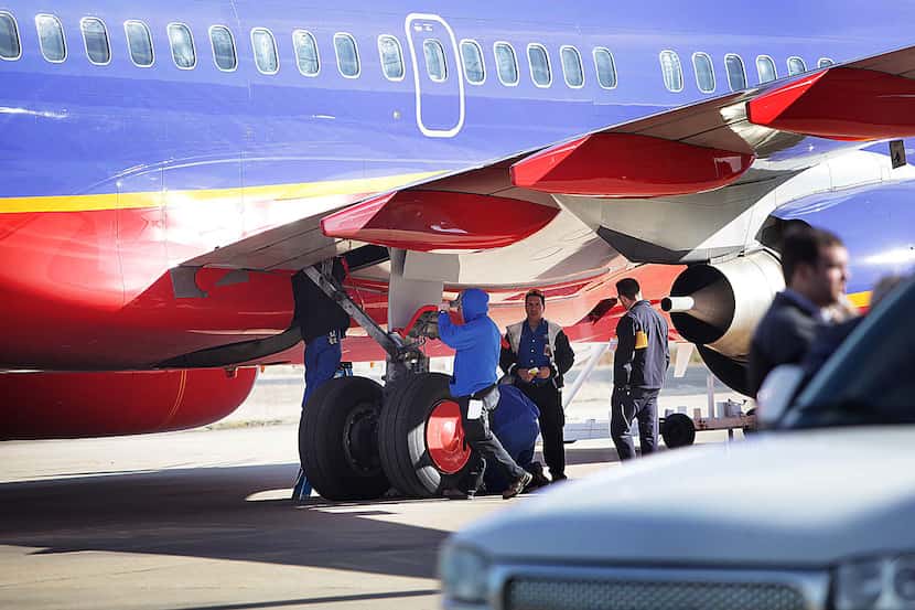 A crew inspected Southwest Airlines Flight 4013  at the M. Graham Clark Airport in...