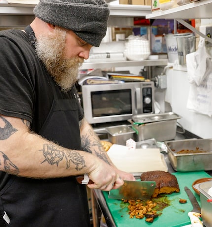 Chef Hank Storm chops vegan brisket made of seitan at VBQ Smokehouse in Fort Worth.