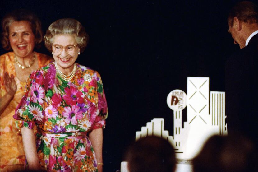 Dallas Mayor Annette Strauss looks on as Queen Elizabeth II and Prince Philip prepare to cut...