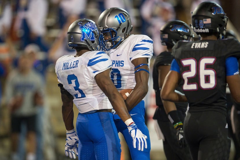 Memphis wide receiver Damonte Coxie (10) bumps helmets with wide receiver Anthony Miller (3)...