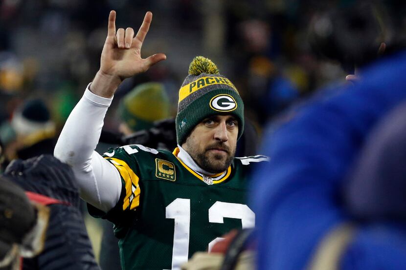 Green Bay Packers quarterback Aaron Rodgers (12) celebrates on the sideline during the...
