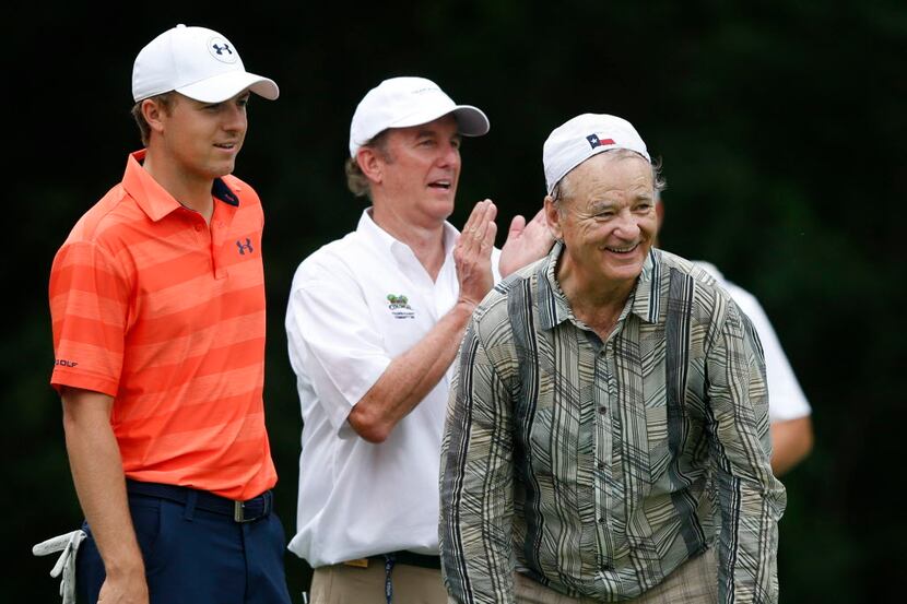 Actor Bill Murray and Jordan Spieth share a laugh after Murray celebrated after hitting a...