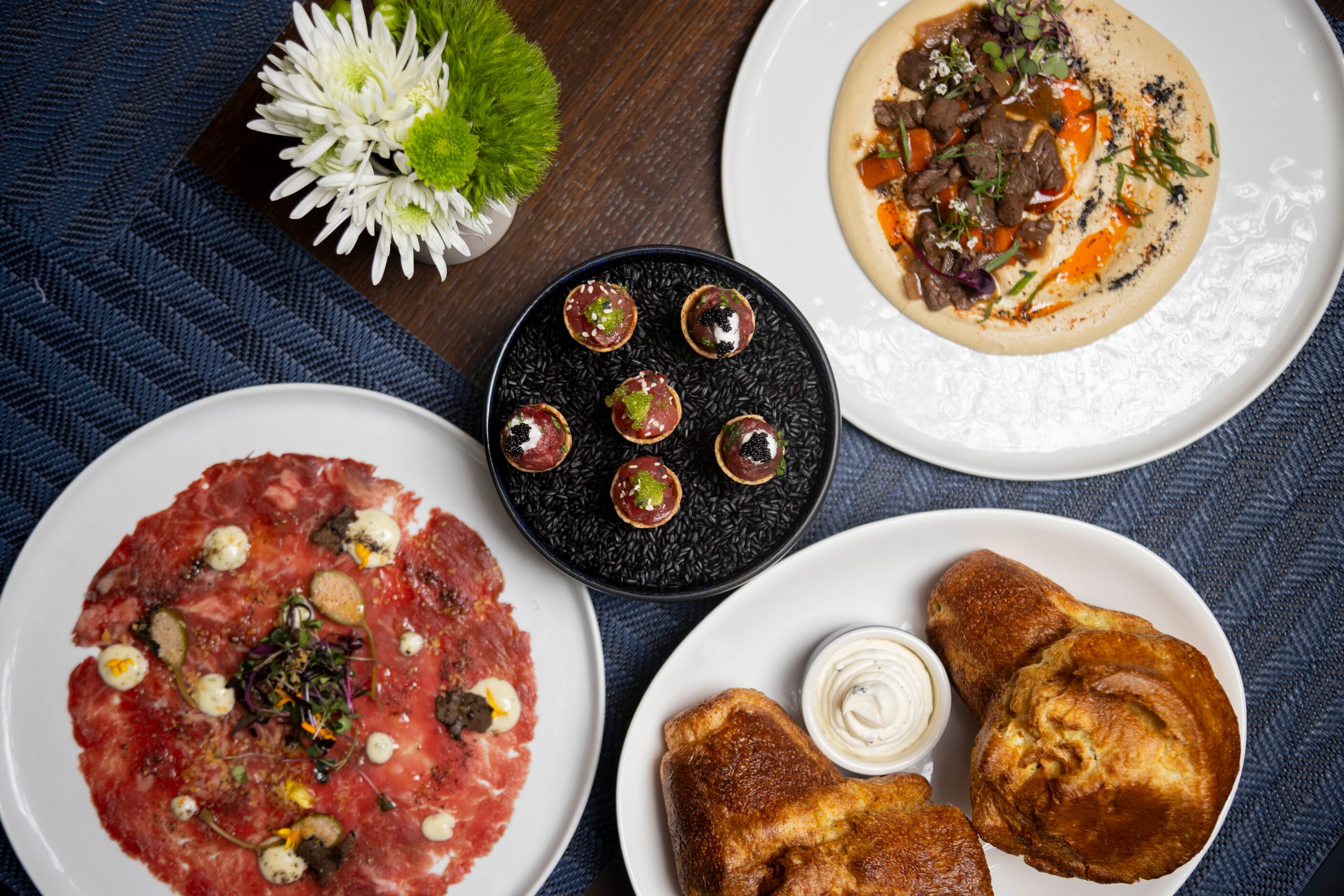 Beef Carpaccio, Steak and Tuna Tartare Cones, bread and Short Rib Hummus are o the menu at...