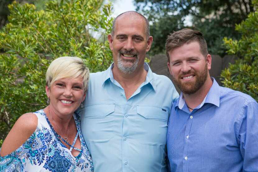 Tamara, left, Charles, and Coty Nelson pose for a photograph at their Leander, Texas home...