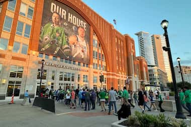 The sun sets as fans enter the American Airlines Center before an NHL hockey game between...