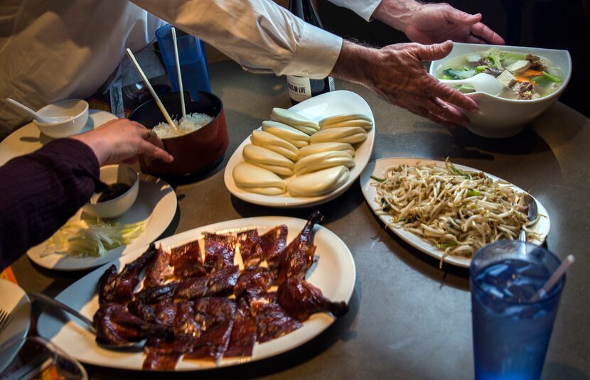 Peking duck "three ways" includes the  crisp roasted bird, steamed bao, stir-fried duck and...