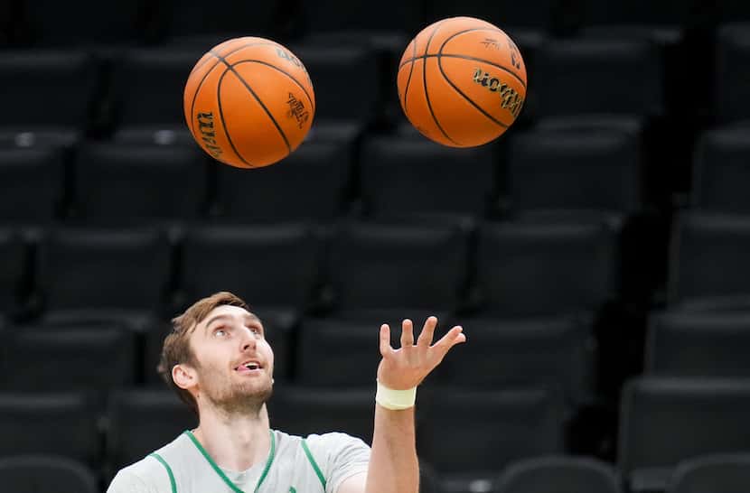 Boston Celtics center Luke Kornet juggles basketballs during a team practice in preparation...